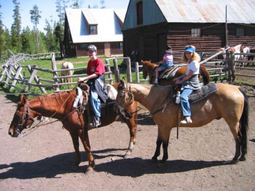 guide with family on horses